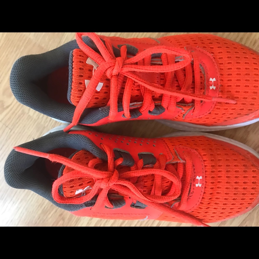 Orange and white Under Armour sneakers
